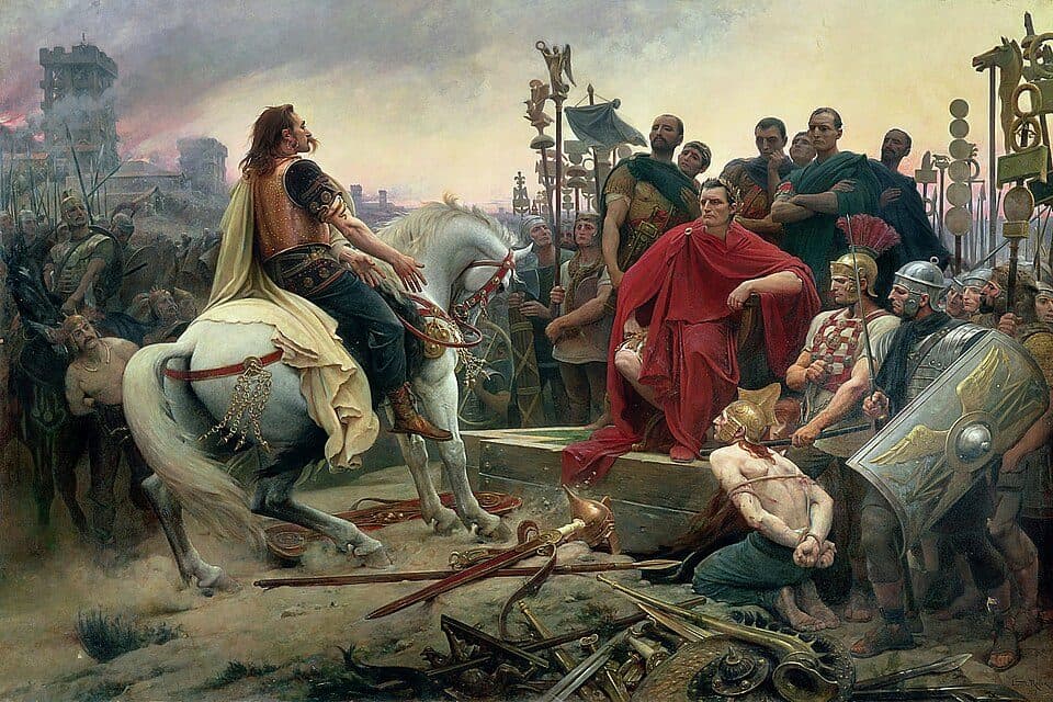 Vercingetorix on horseback throws down his arms before Caesar